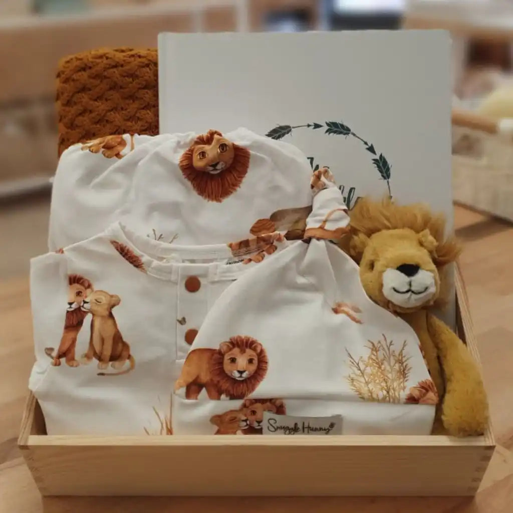 Baby gift set with lion-themed clothing and plush toy.