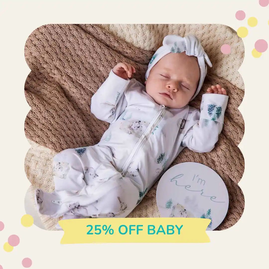 Sleeping baby in patterned onesie.