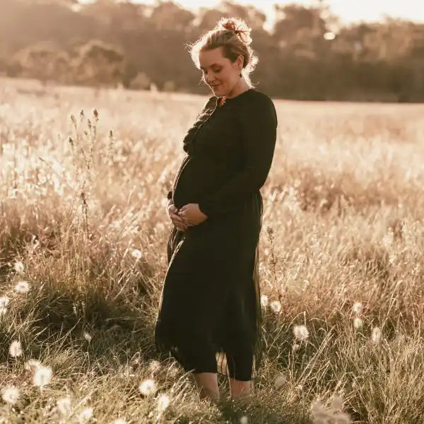 Pregnant woman in black dress.